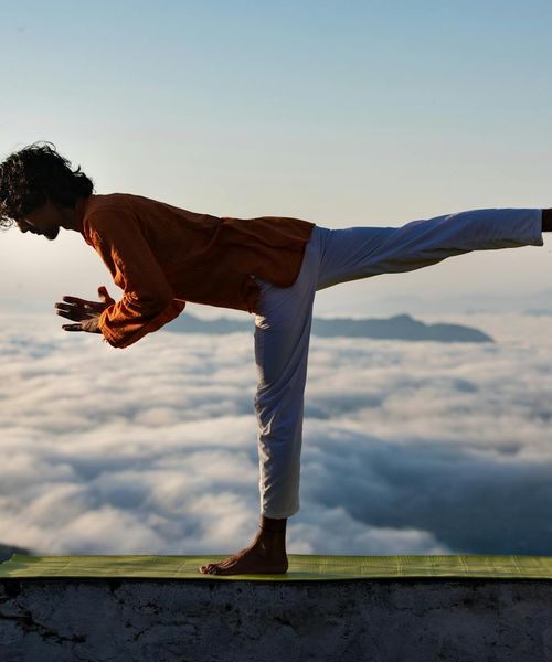 Silhouette of a man in a calm, meditative pose.